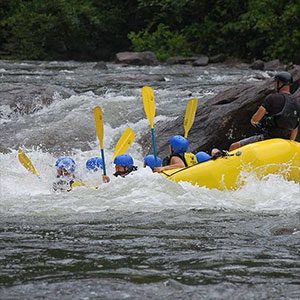 A group of people in a raft on a river.