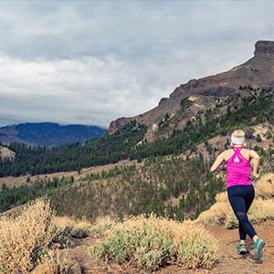 A landscape portrait with a woman running.